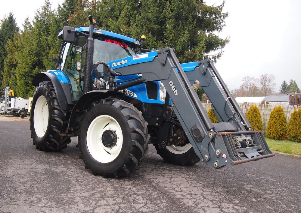 Ciągnik New Holland NH TS125A 6 cylindrów 2004 Ciągnik rolniczy New Holland TS125A - Traktor: das Bild 2 Ciągnik New Holland NH TS125A 6 cylindrów 2004 Ciągnik rolniczy New Holland TS125A - Traktor: das Bild 2
